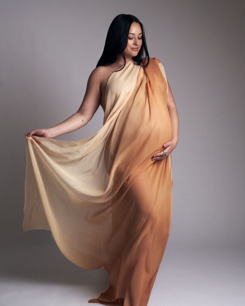 What to wear for maternity photos in Phoenix studio session with elegant neutral gown