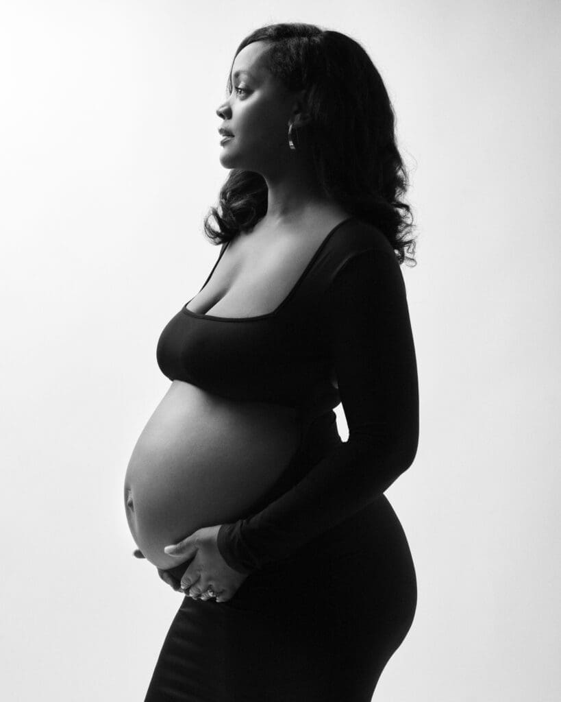Soft editorial maternity portrait with neutral styling