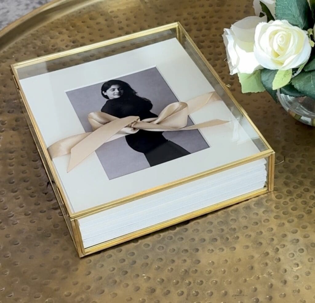 Image of a folio box on a coffee table with matted prints of pregnant woman